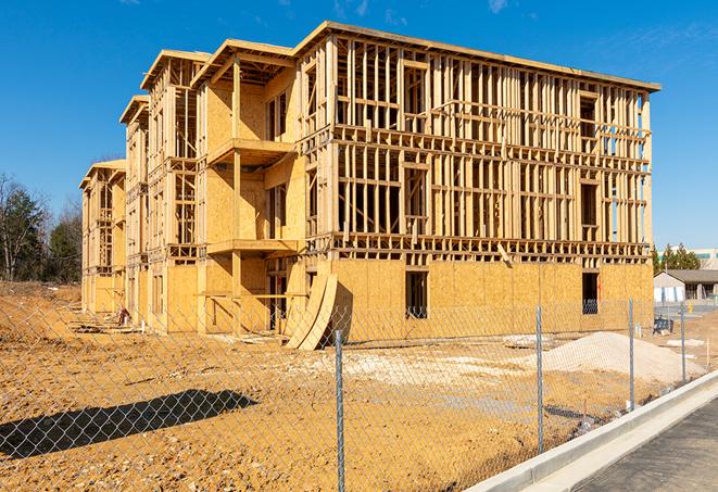 workers protected by temporary barrier fence during building maintenance in San Clemente CA